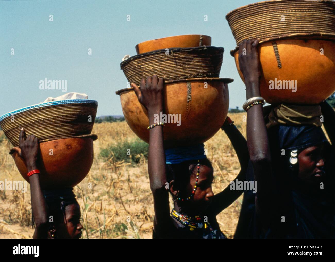 Filles peules transportant des produits laitiers sur leur tête pour les vendre, Gourma-Rharous, Dialloube, Mopti, au Mali. Banque D'Images