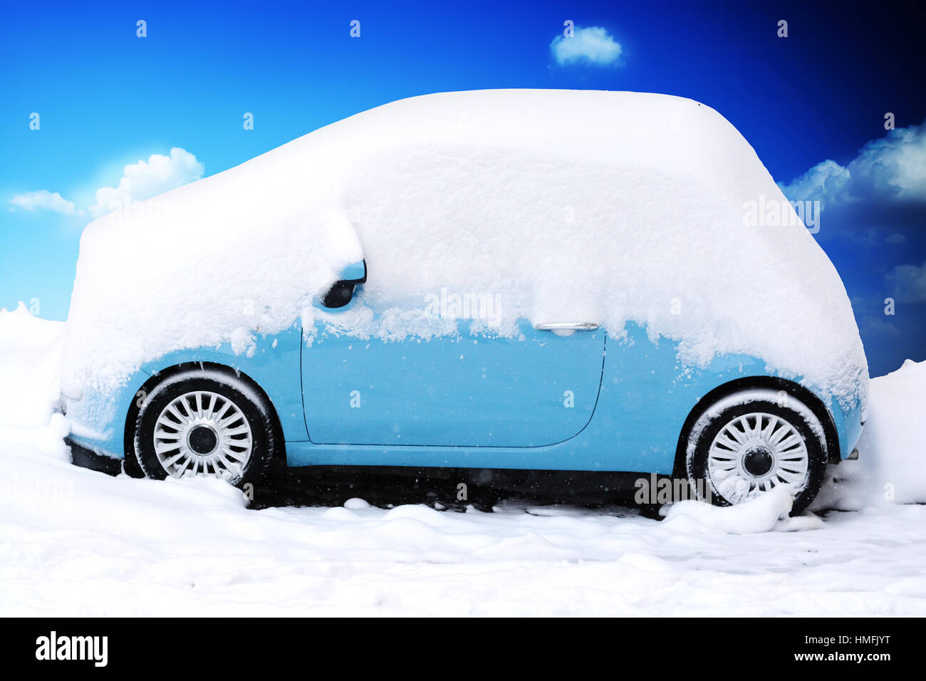 Voiture bleue couvert et entouré de neige après une tempête de neige Banque D'Images