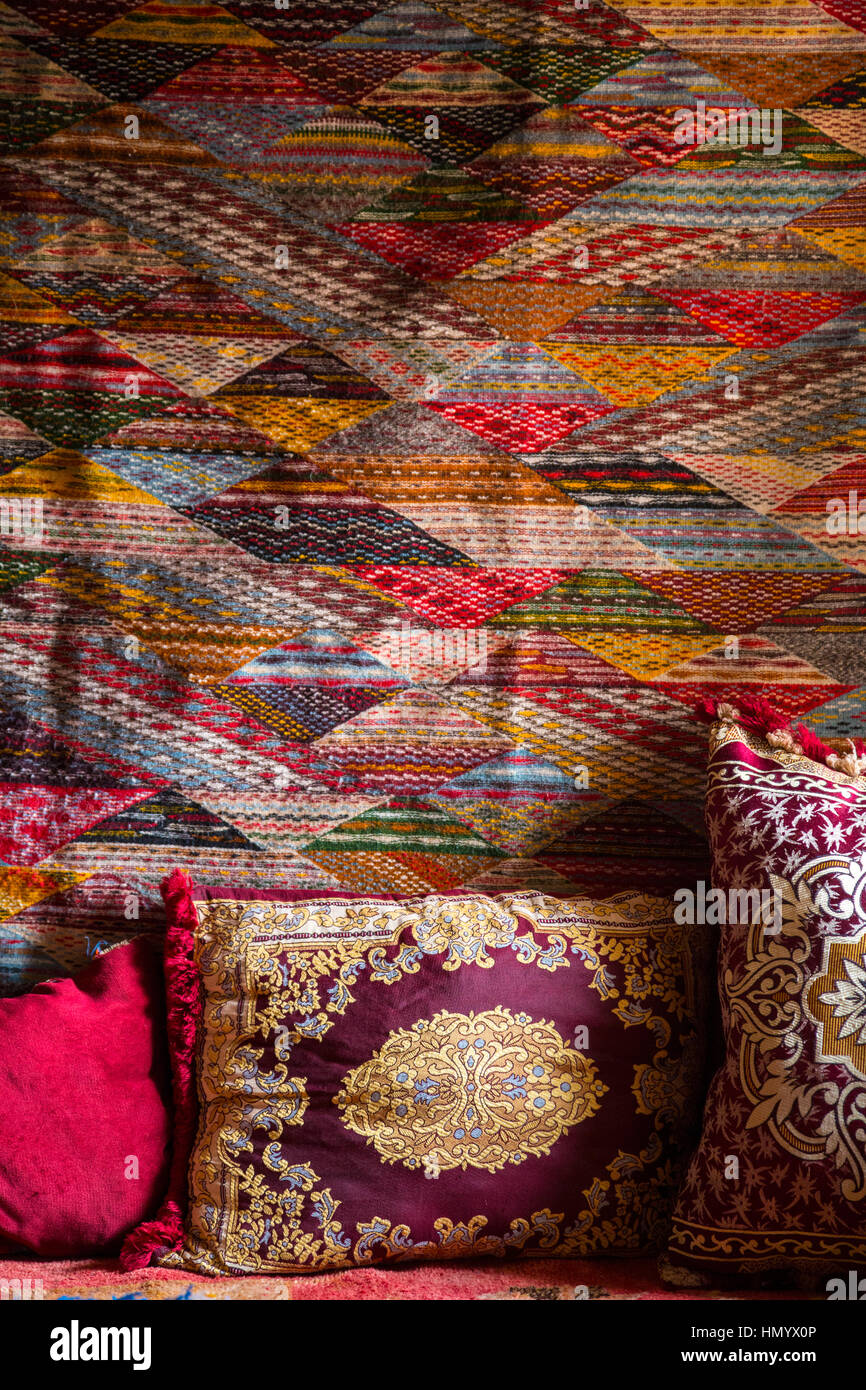 Le Maroc. Coussins de salon et tenture murale dans une maison à Ksar Ait Benhaddou, un site du patrimoine mondial. Banque D'Images