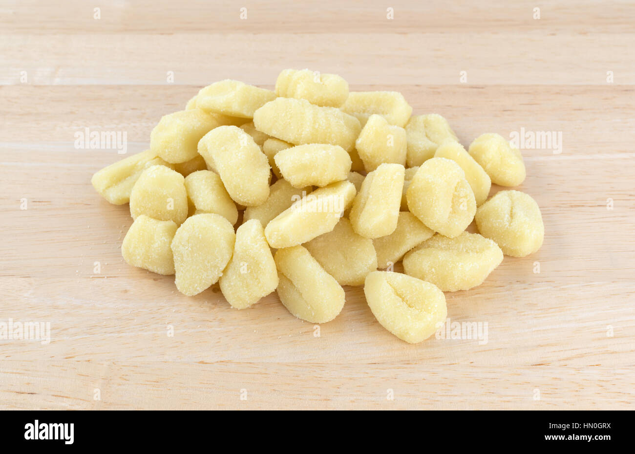 Une partie des gnocchi de pommes de terre sur un simple comptoir de bois. Banque D'Images