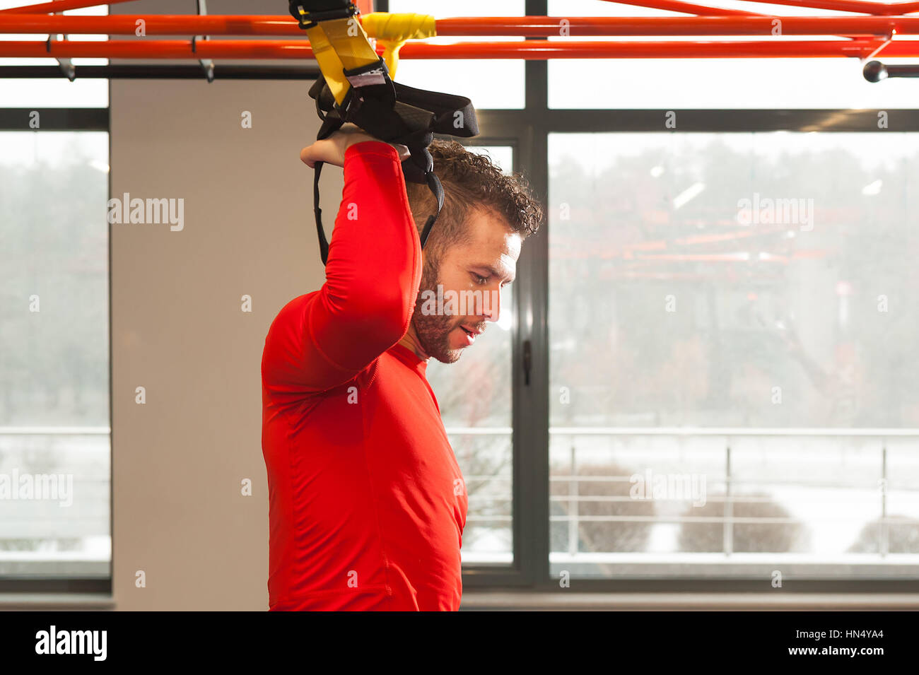 Formation TRX. Instructeur Crossfit au gym faire Excersise TRX. Homme Fitness workout sur les anneaux. Homme remise en forme dans la salle de sport. Style de remise en forme. Entraînement sur joints toriques. Sport et fitness. Entraînement Crossfit Banque D'Images