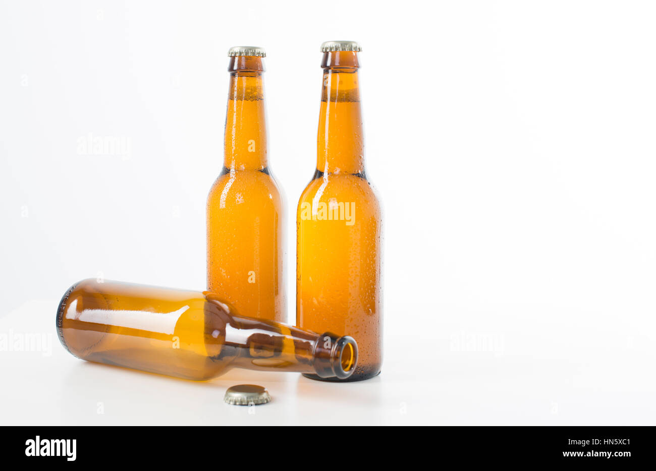 Vide et Plein de bouteilles de bière brune sur un fond blanc Banque D'Images