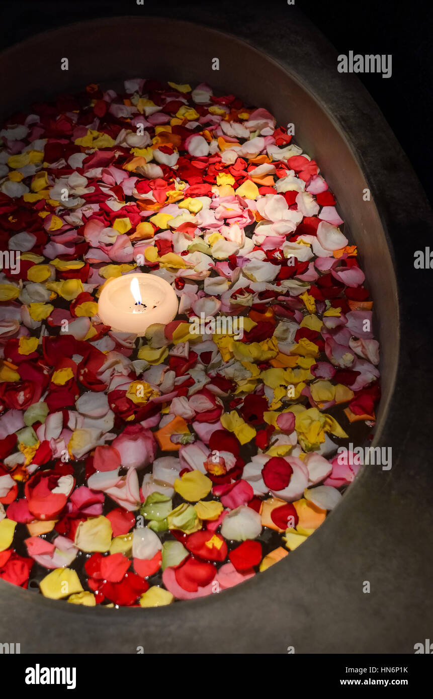 Baignoire flottante avec des pétales de rose et des bougies dans la pièce  sombre Photo Stock - Alamy