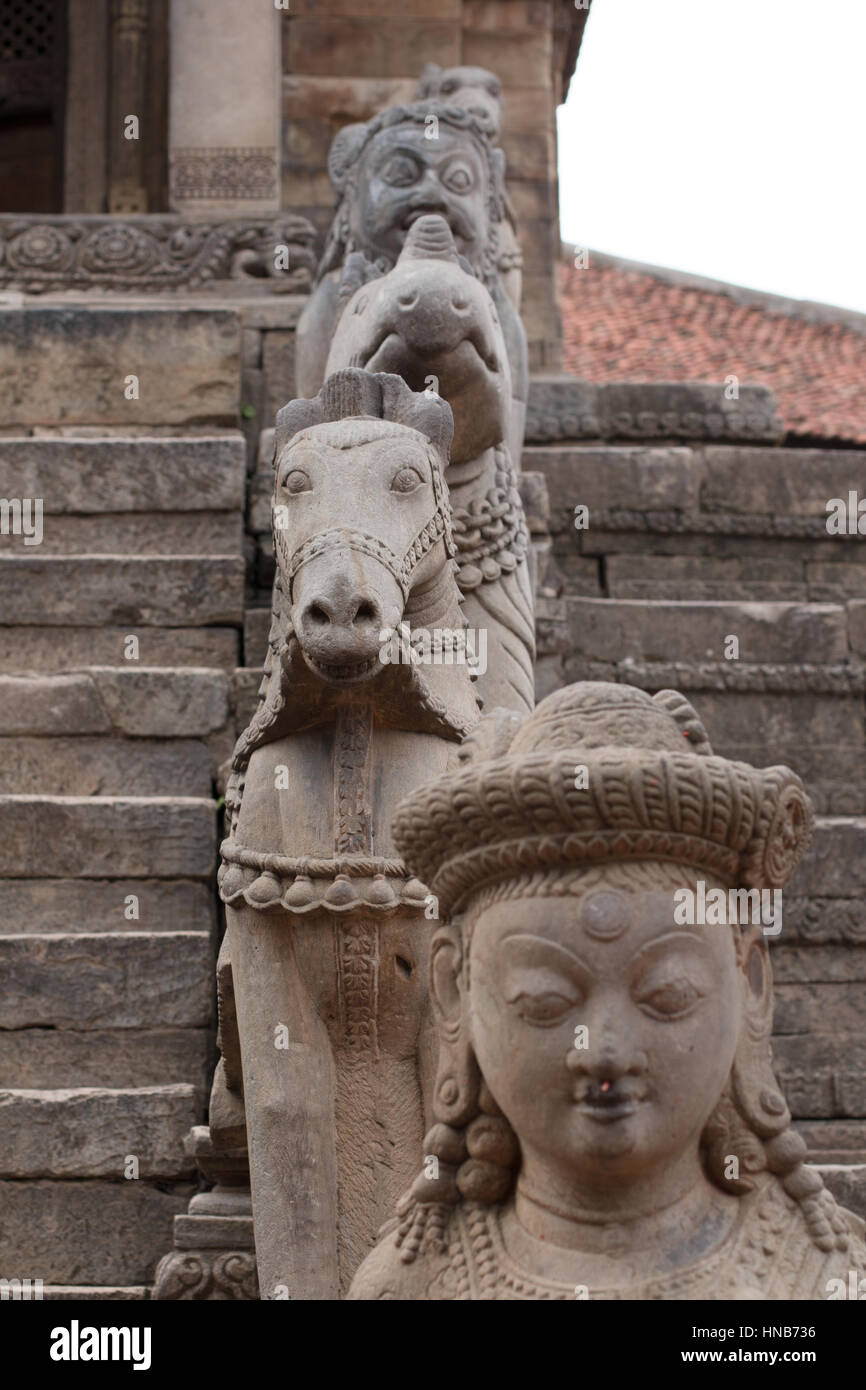 L'homme, le cheval et le stand d'asura sculpté dans la pierre sur les marches d'un temple à Katmandou, Bhaktapur Banque D'Images