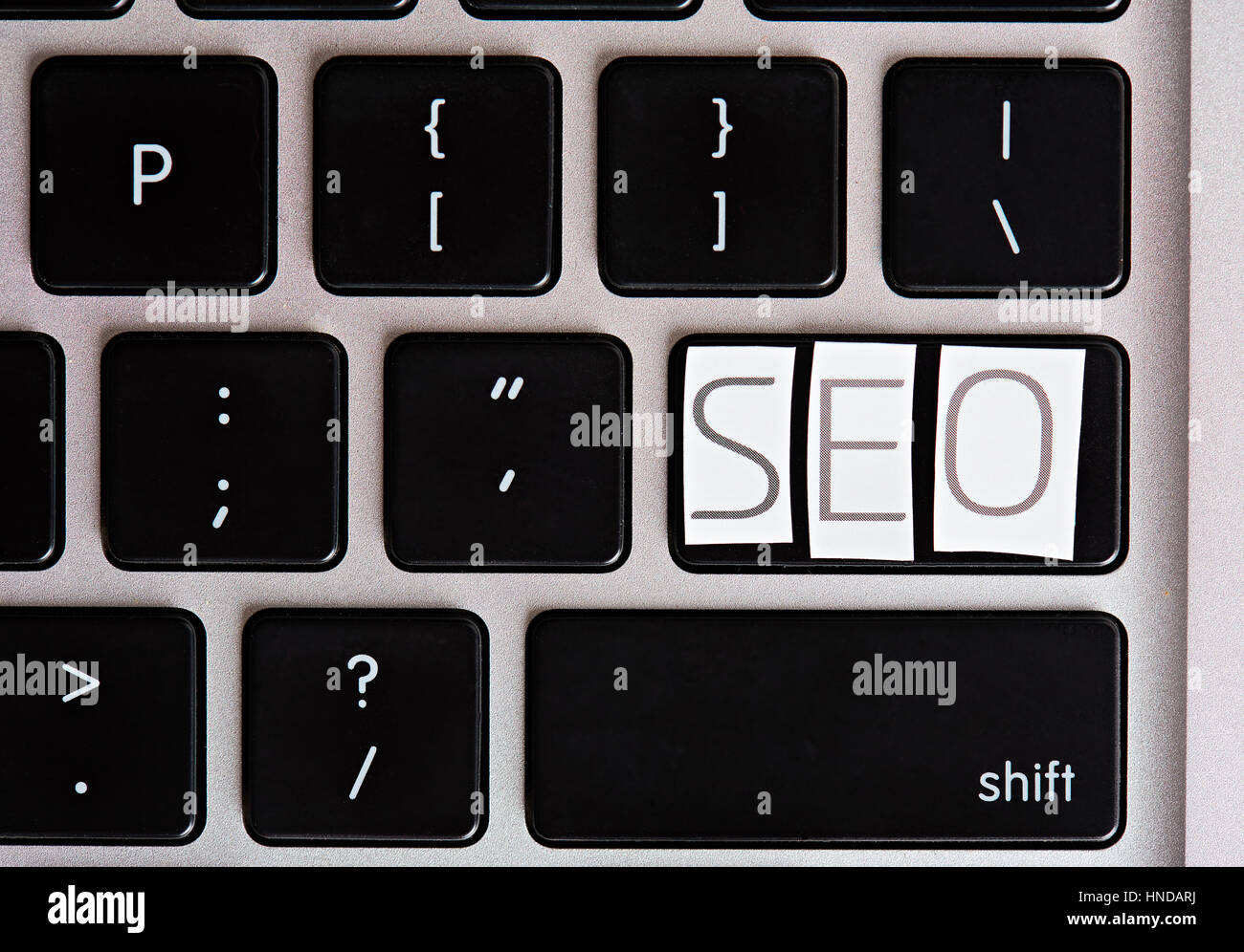 Lettres sur le bouton clavier SEO de découpe magazine Banque D'Images