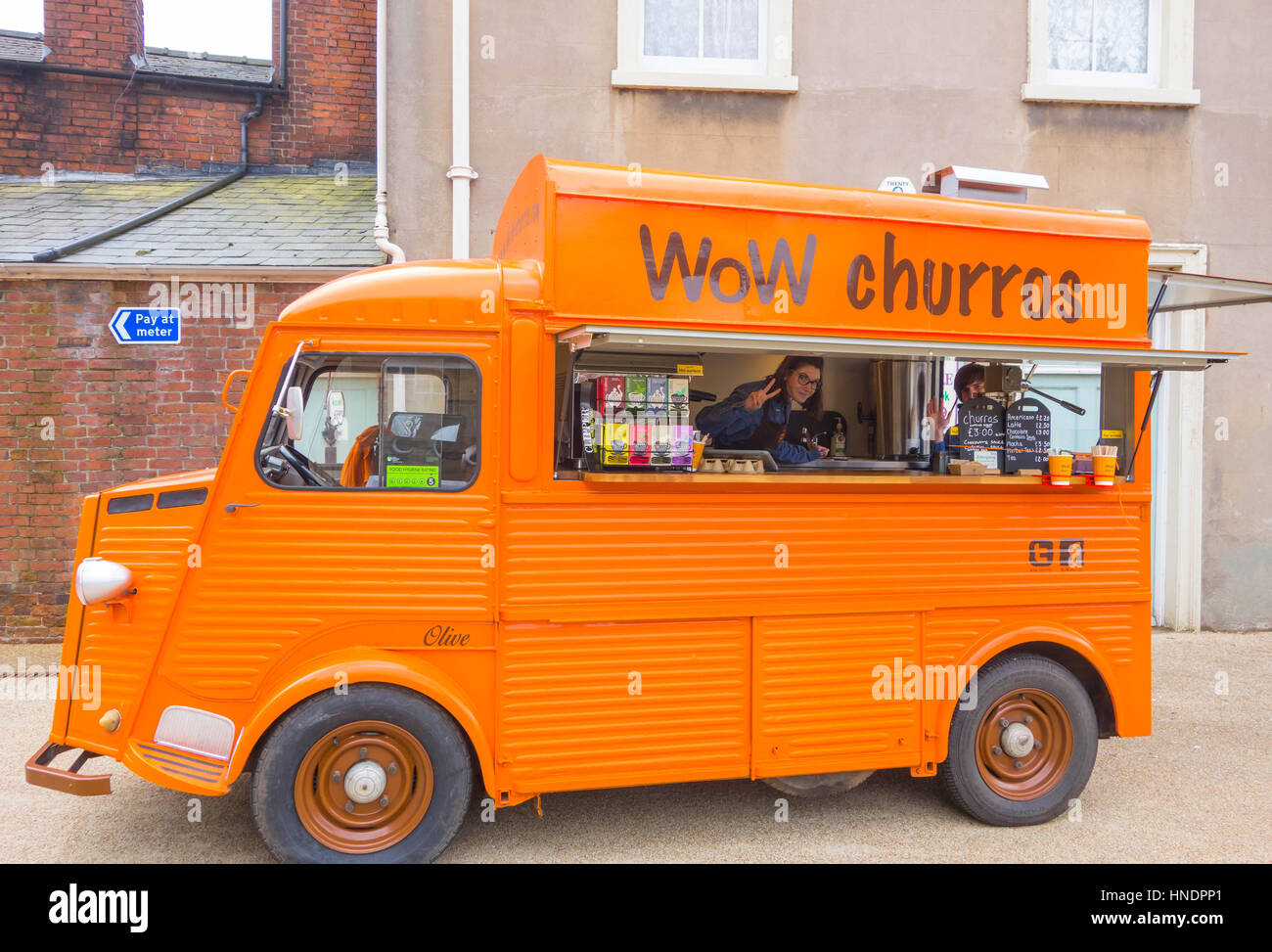 Citroen Orange snack-van de vendre des churros avec les propriétaires gesticulant de l'intérieur Banque D'Images