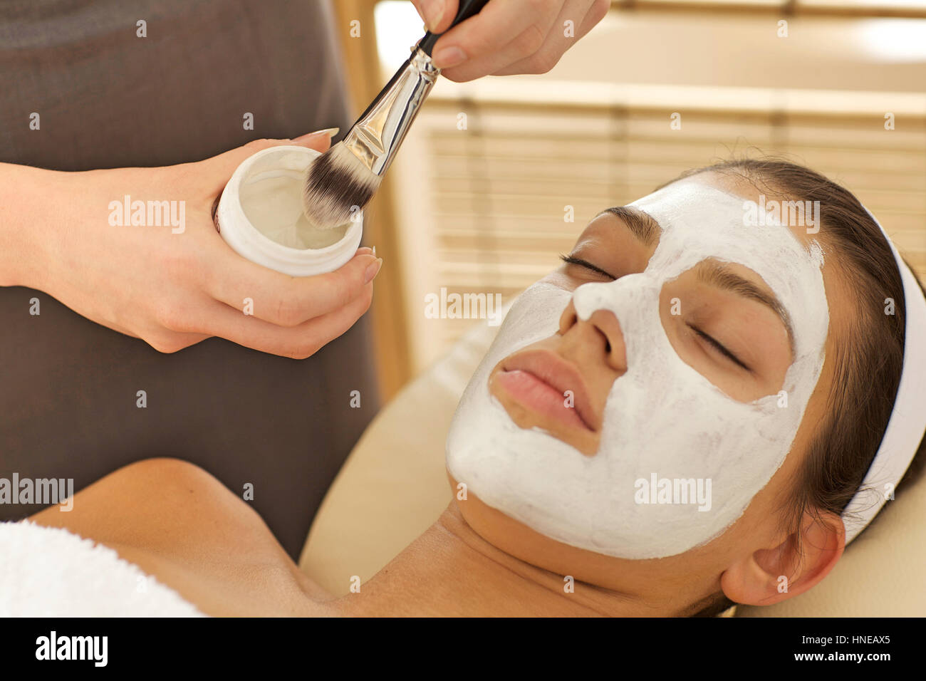 Close-up of young woman with facial mask Banque D'Images