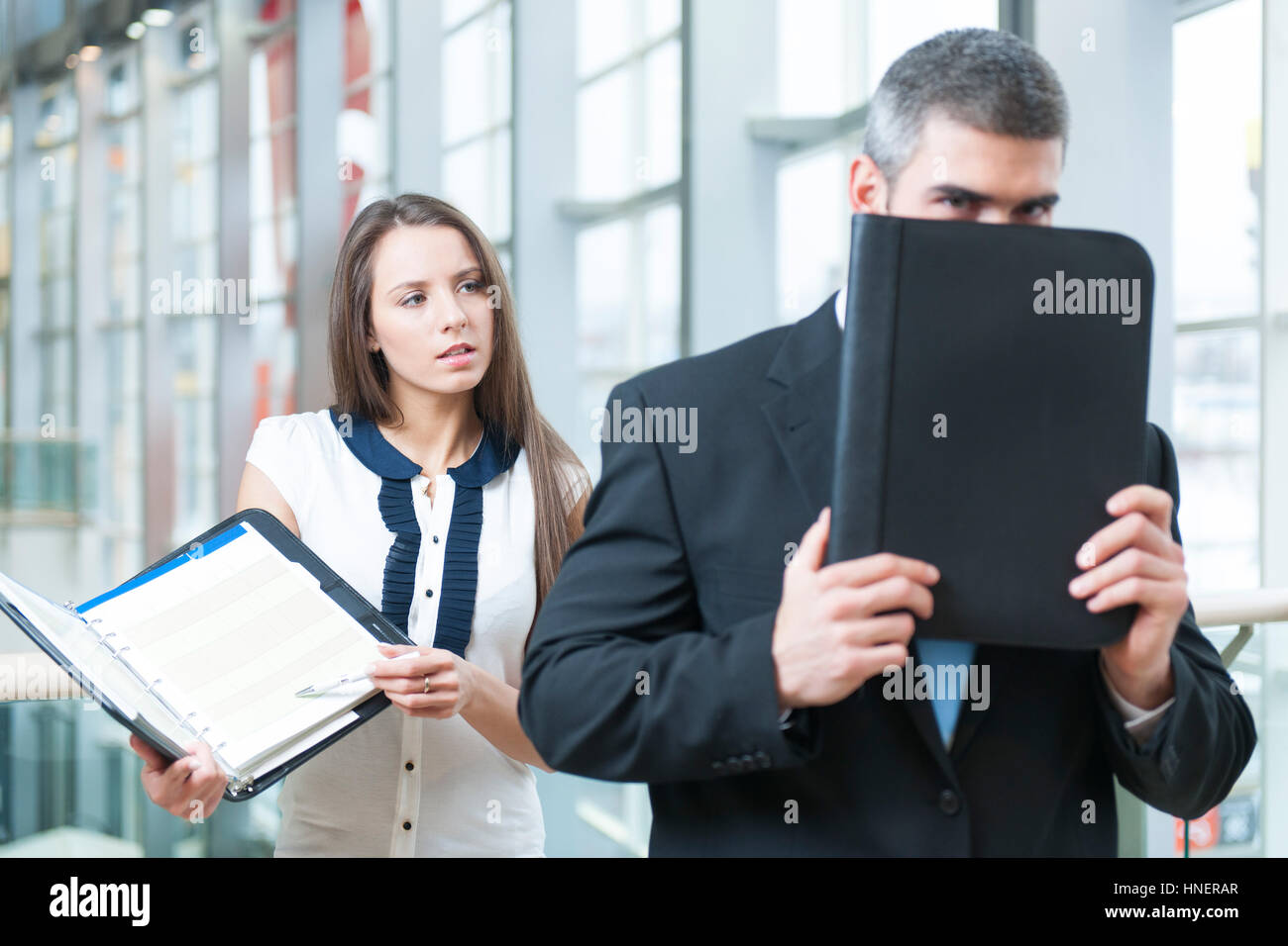 Businessman se cache derrière un collègue folder Banque D'Images