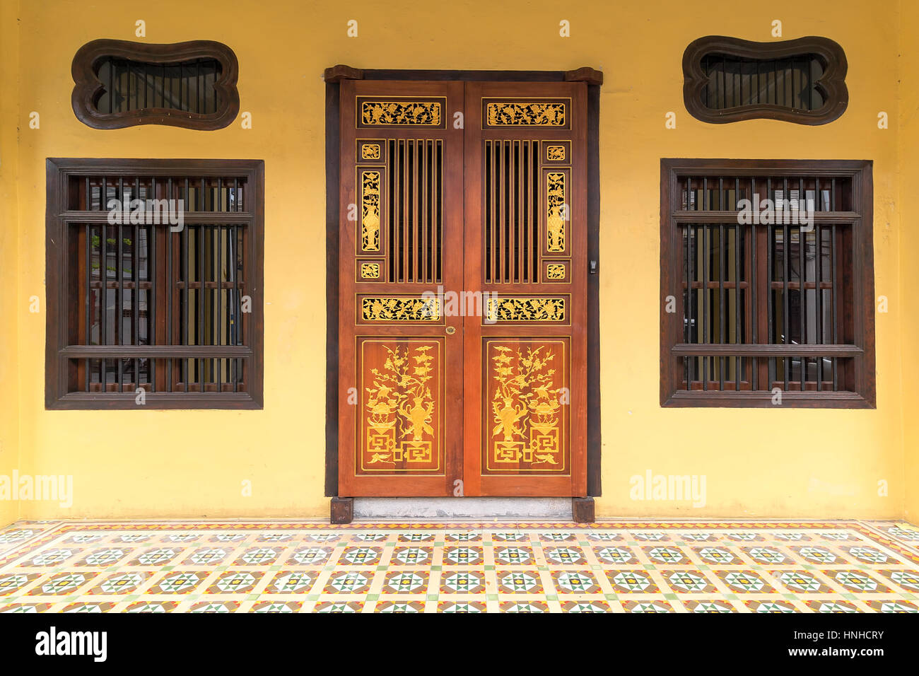 Fenêtres de style typique Peranakan et des portes d'accès avec un sol en céramique à Penang, Malaisie Banque D'Images