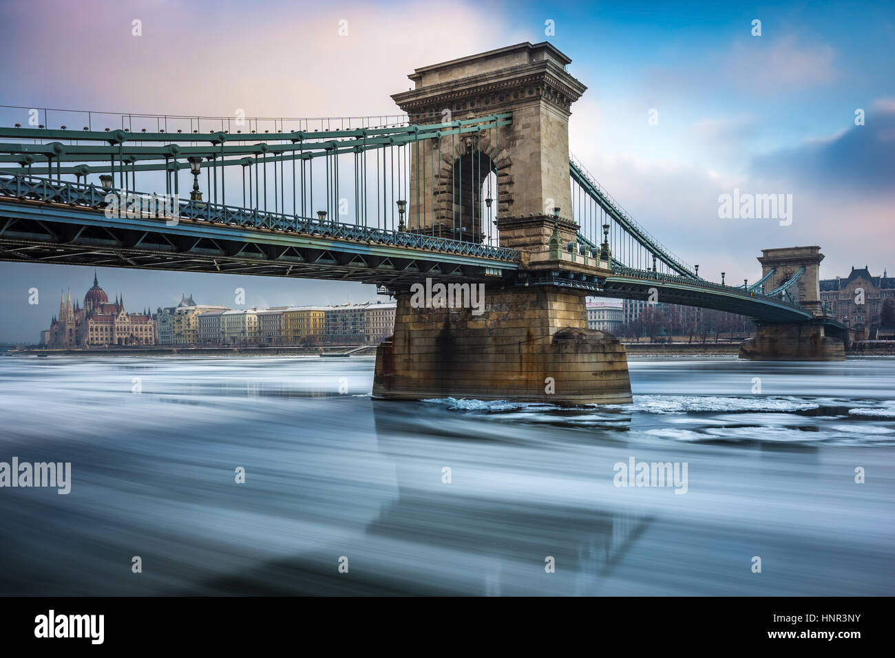 Budapest, Hongrie - le célèbre Pont des chaînes Széchenyi icy sur le Danube sur un froid matin d'hiver avec le Parlement hongrois à l'arrière-plan Banque D'Images