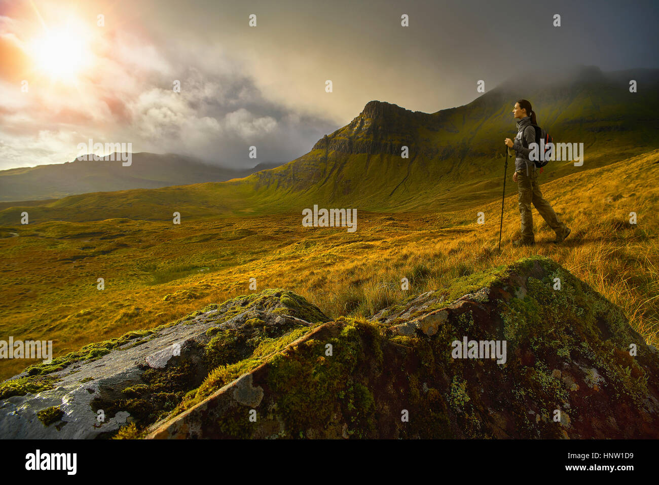 Caucasian woman hiking dans paysage de montagne verte Banque D'Images