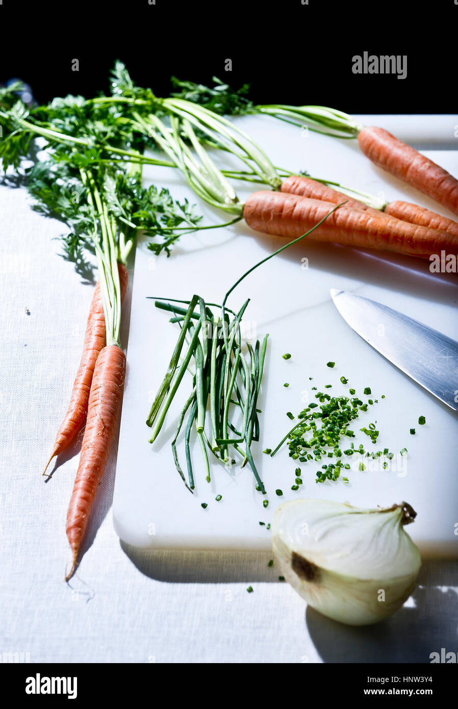 Les légumes et knife on cutting board Banque D'Images