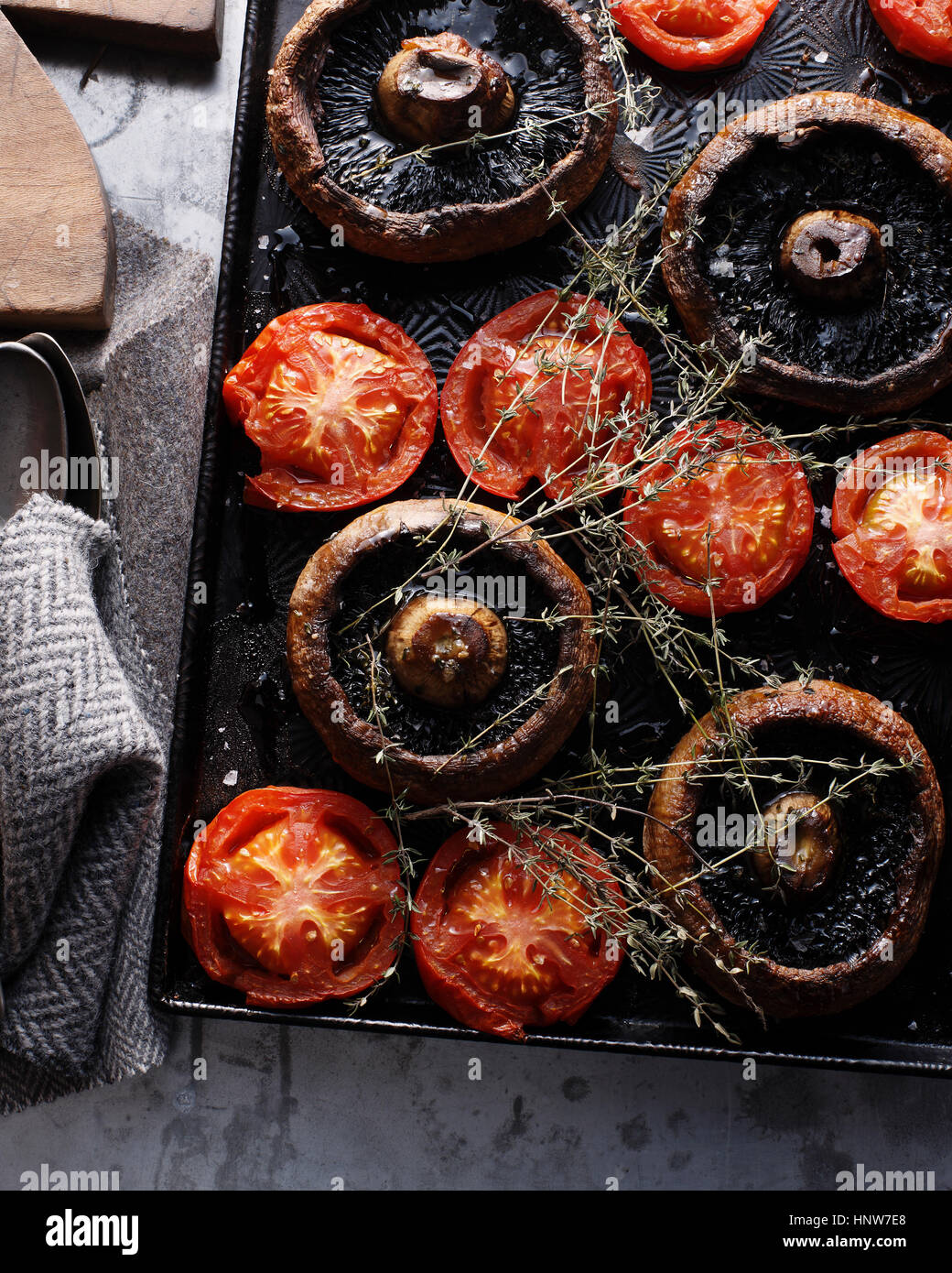 Les champignons et les tomates au four sur la plaque de cuisson Banque D'Images
