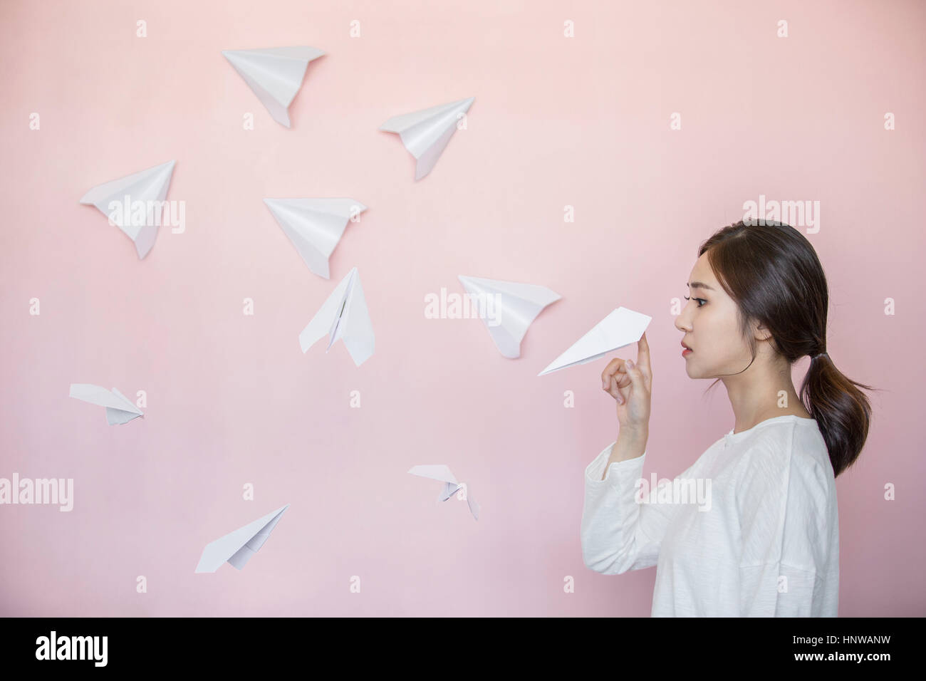 Jeune femme avec beaucoup d'avions en papier Banque D'Images