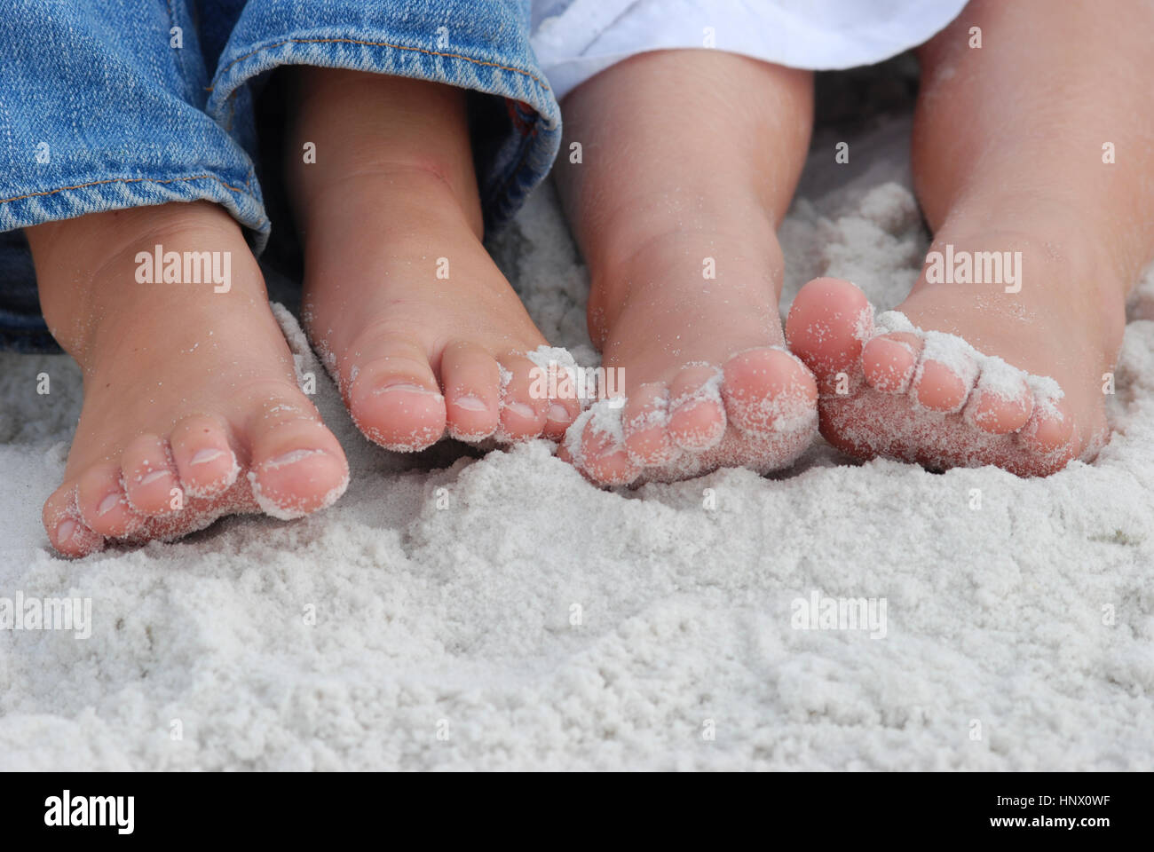 Chidrens' pieds, Close up, illustré dans le sable Banque D'Images