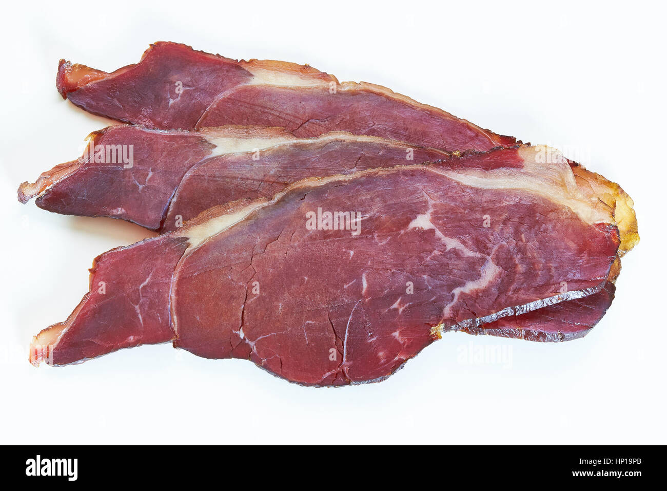 Tranches de boeuf fumé (viande séchée) isolé sur fond blanc Banque D'Images