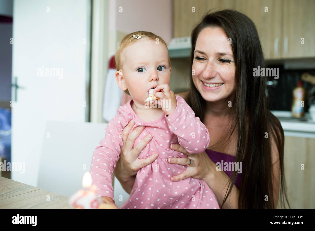 Mère avec son joli fille manger son gâteau d'anniversaire Banque D'Images