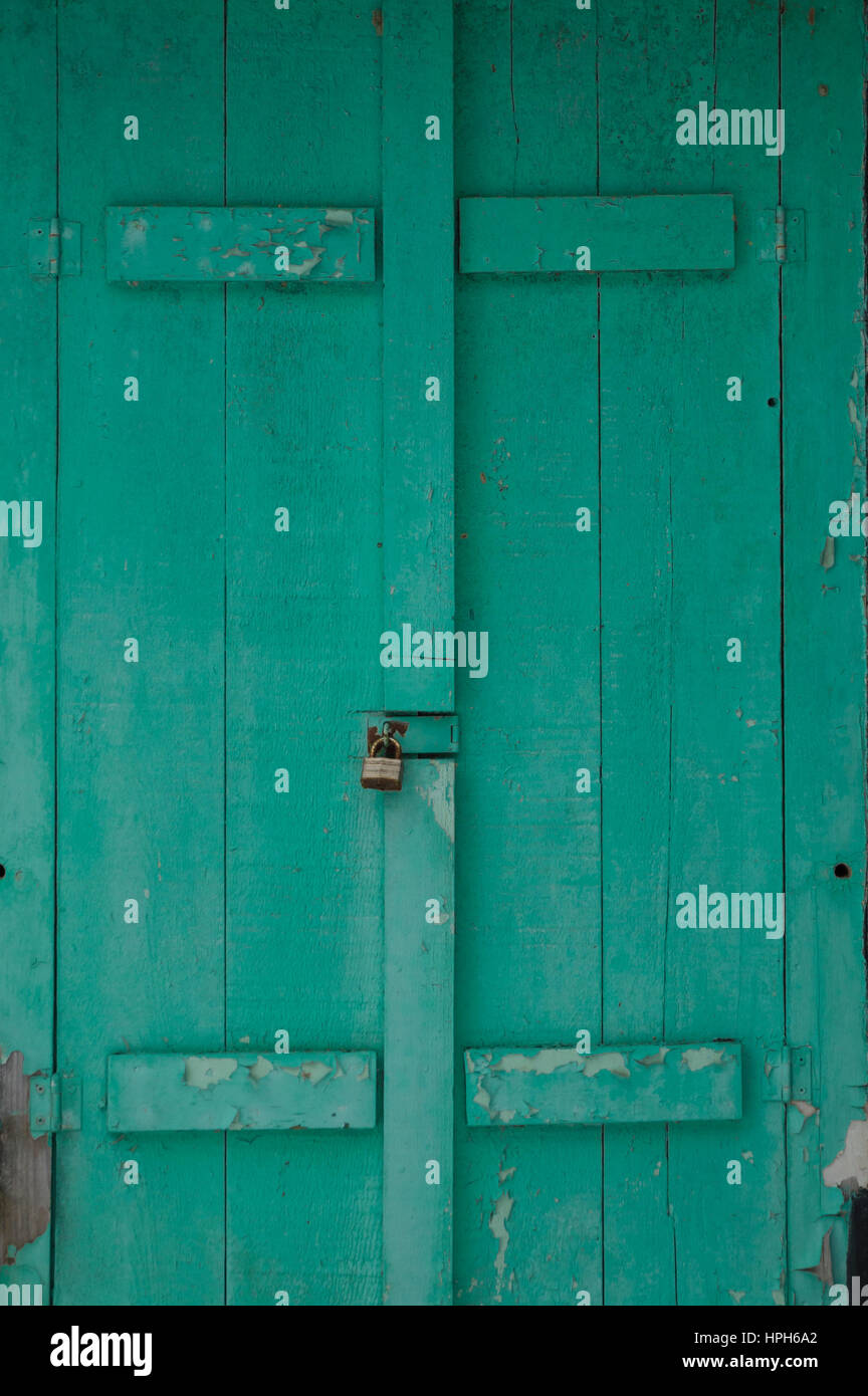 Shuuters mildewy vert pâle grunge sur un chalet. Verrouillé sur un chalet noir en hiver Banque D'Images