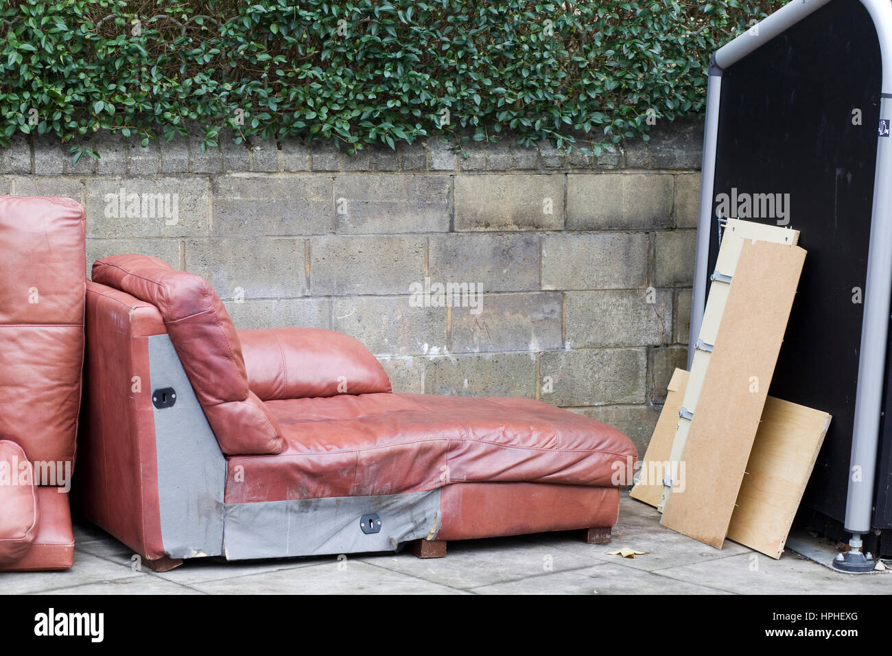 Canapé en cuir d'un dumping sur le trottoir à Londres 'fly tipping' Banque D'Images