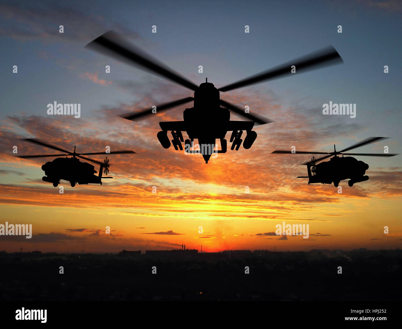 Silhouette de trois hélicoptères militaires au coucher du soleil Banque D'Images