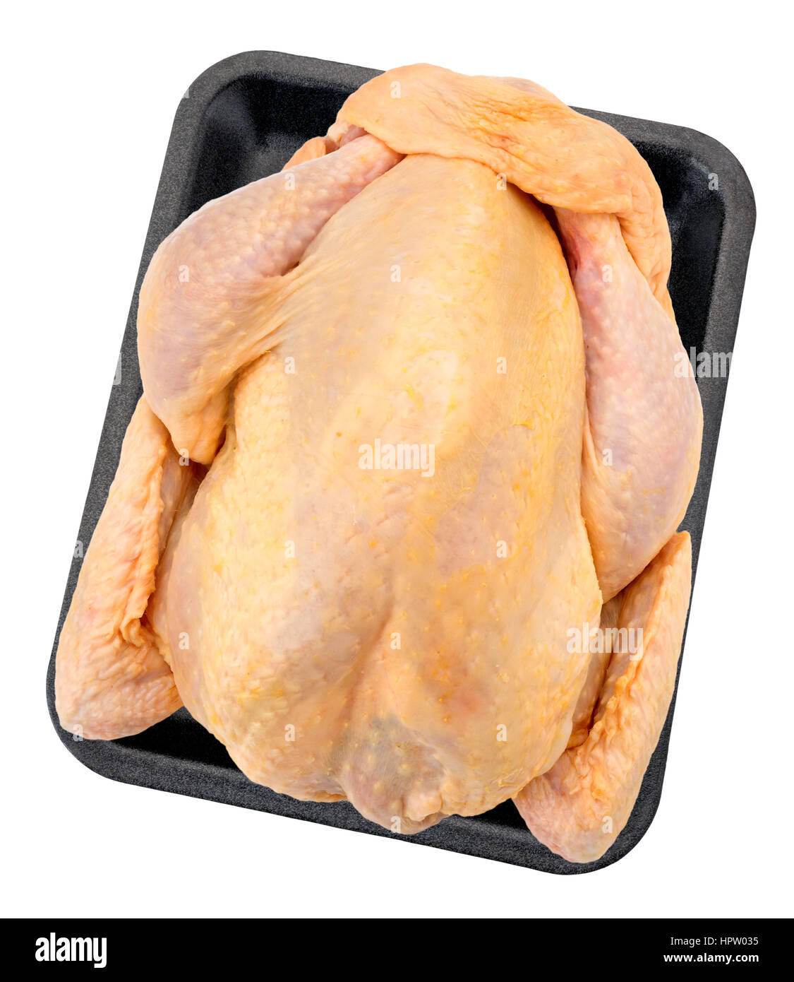 Poulet cru entier sur un contenant en plastique( +clipping path) Banque D'Images