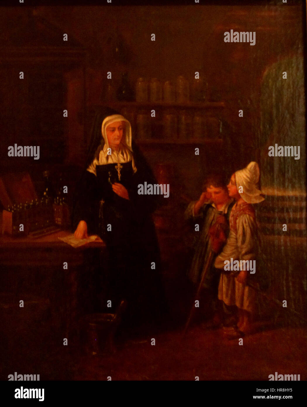 Cette œuvre d'un peintre néerlandais inconnu représente une scène d'une pharmacie monastique, où des moines préparent des herbes médicinales et des remèdes. La peinture offre un aperçu de la vie monastique et du rôle des monastères dans la fourniture de soins de santé pendant la période médiévale. Banque D'Images