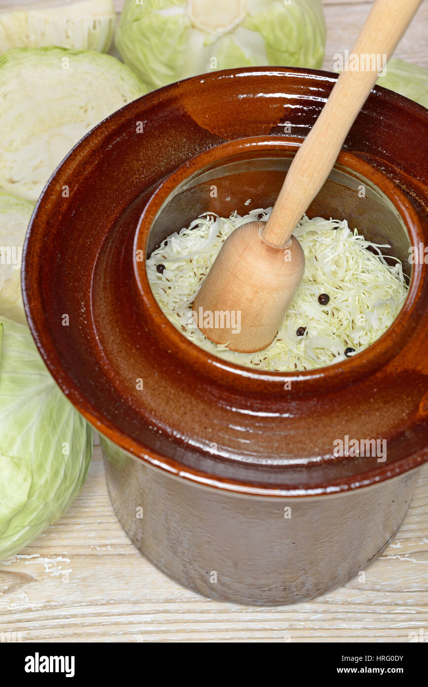 La fermentation des aliments, rendant la choucroute : chou blanc avec un motif en pounder dans une cruche de la récolte Banque D'Images