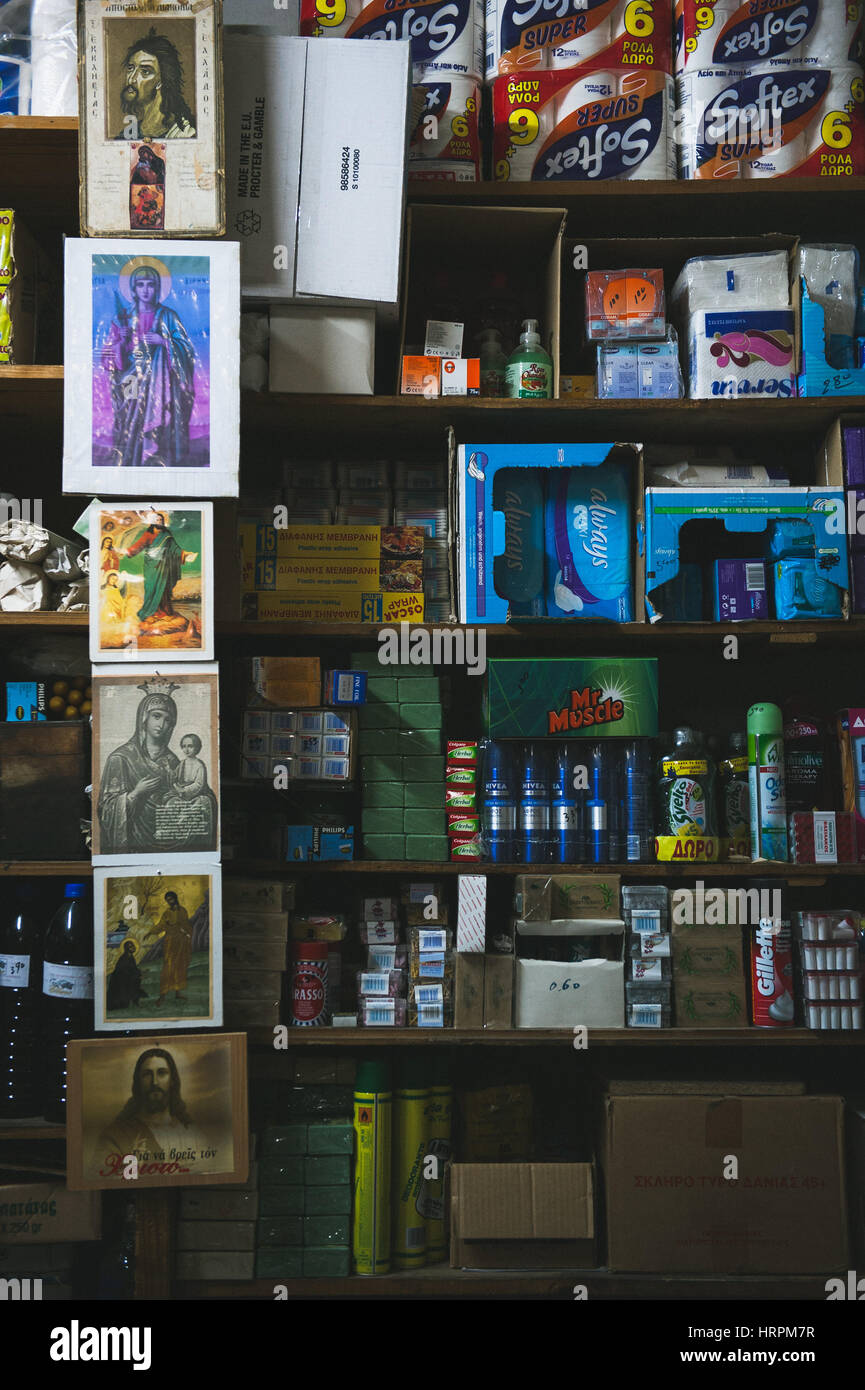 L'affichage des produits à vendre avec des icônes religieuses dans une ancienne boutique traditionnelle de la mode à l'intérieur du château de Chios. Banque D'Images