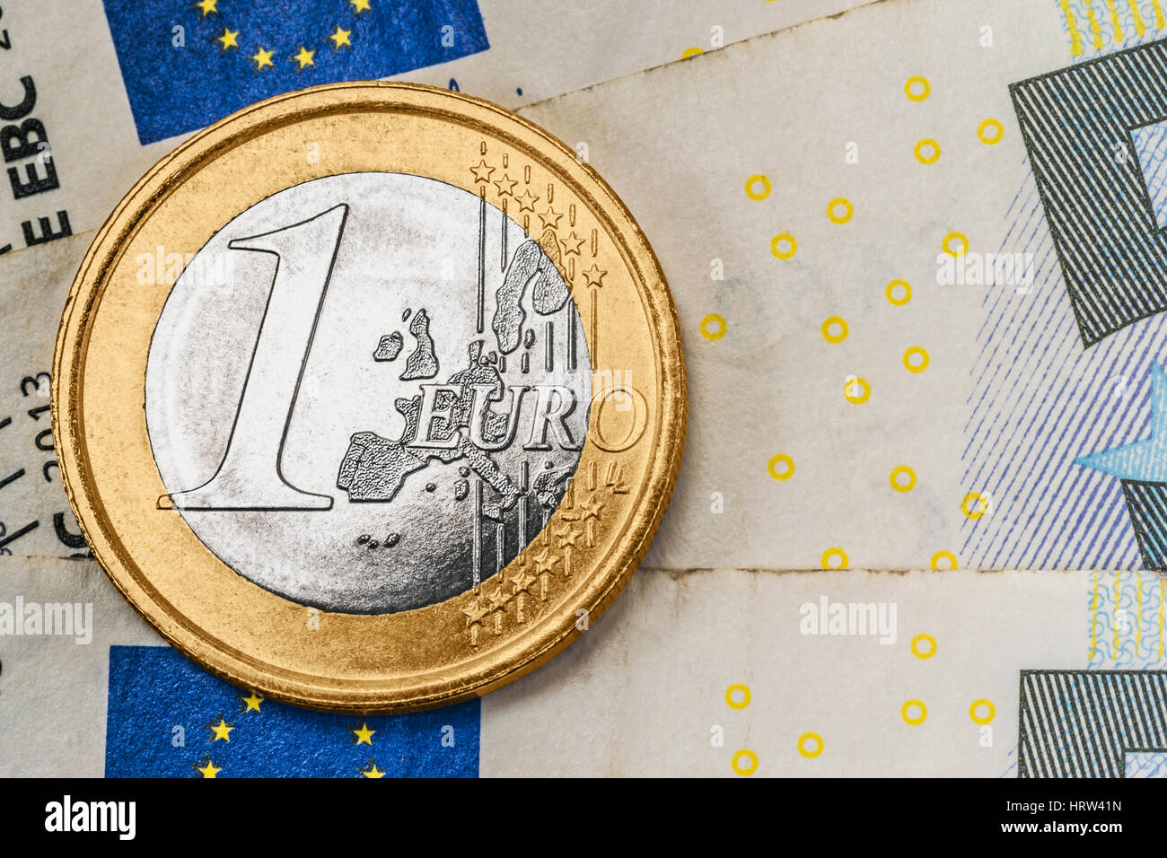 Une pièce de 1 euro sur les billets en euros Banque D'Images