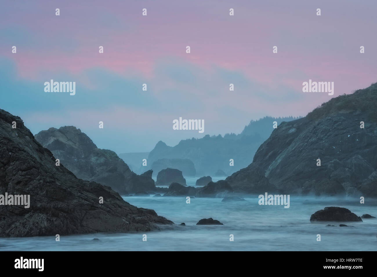 Coucher du soleil voilé la lumière à Harris Beach State Park, le sud de l'Oregon coast. Banque D'Images