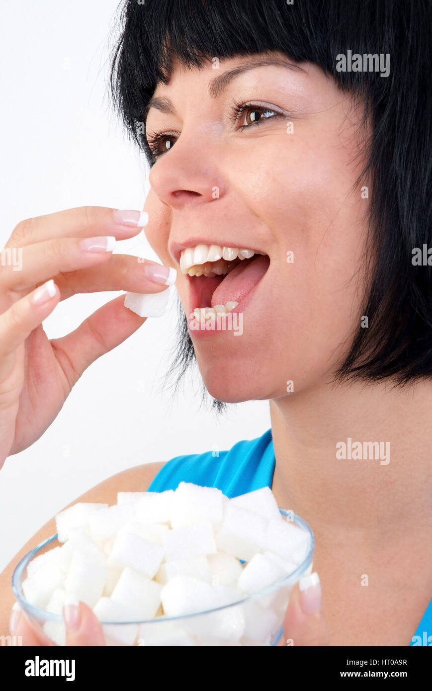 Frau isst W ?rfelzucker - femme mange de sucre forfaitaire Banque D'Images