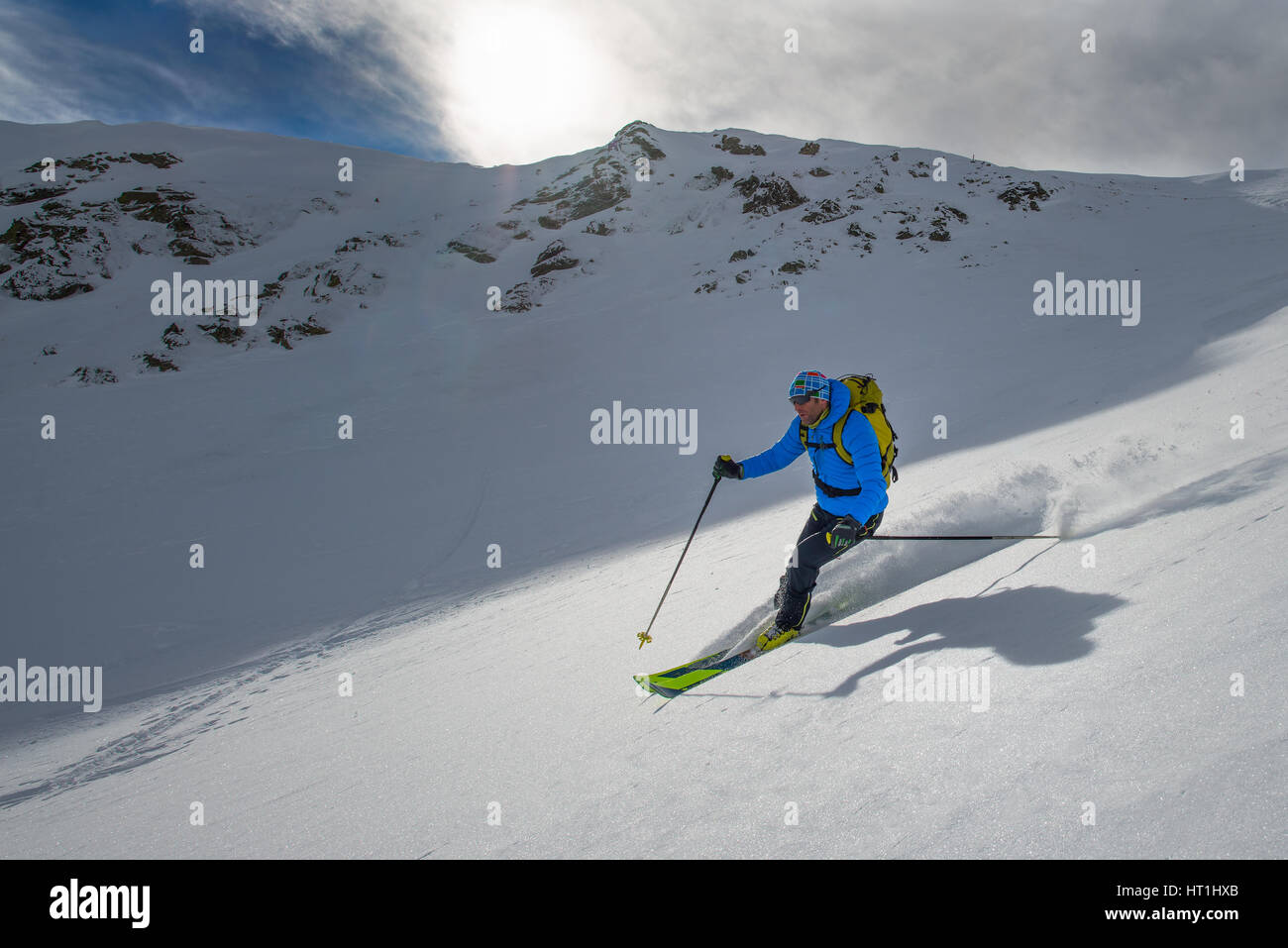 Skieur dans l'arrière-pays de la neige fraîche dans belle journée ensoleillée Banque D'Images