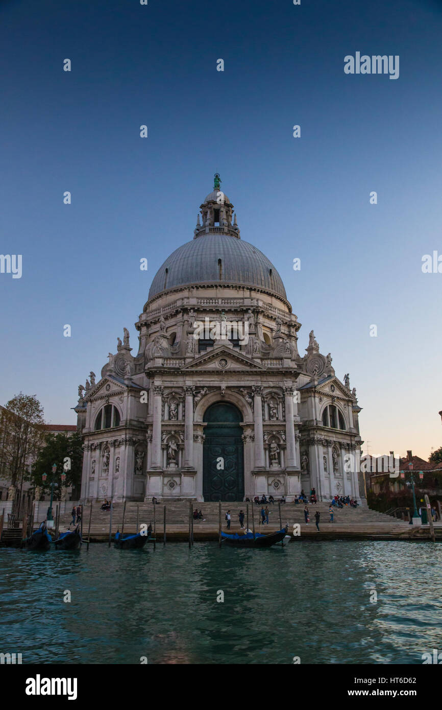 Coucher du soleil au Grand Canal long exposre à Basilica di Santa Maria della Salute à Venise, Italie avec un ciel bleu profond et un bel éclairage Banque D'Images