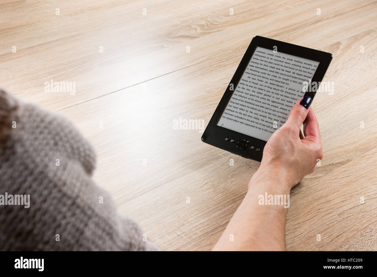 Woman holding ebook reader en face de la table Banque D'Images