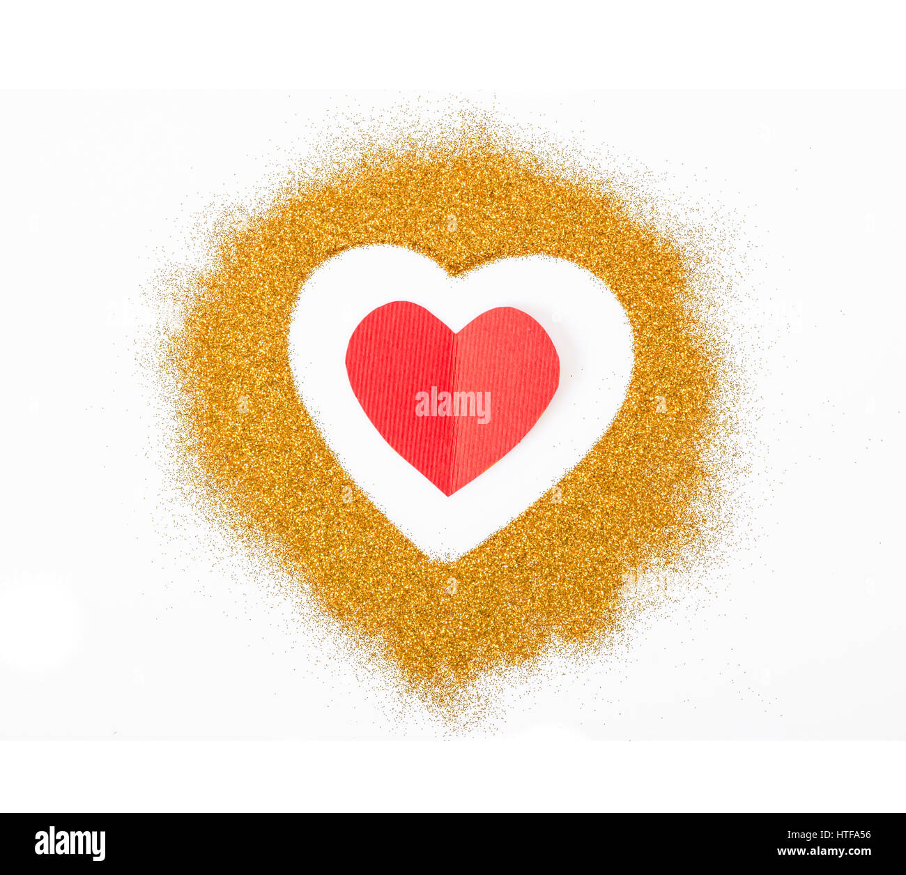 Golden Heart glitter et carton rouge sur fond blanc. Banque D'Images