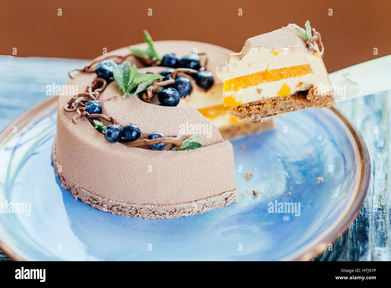 Gâteau à la crème délicieux coupe libre sur la plaque bleue Banque D'Images