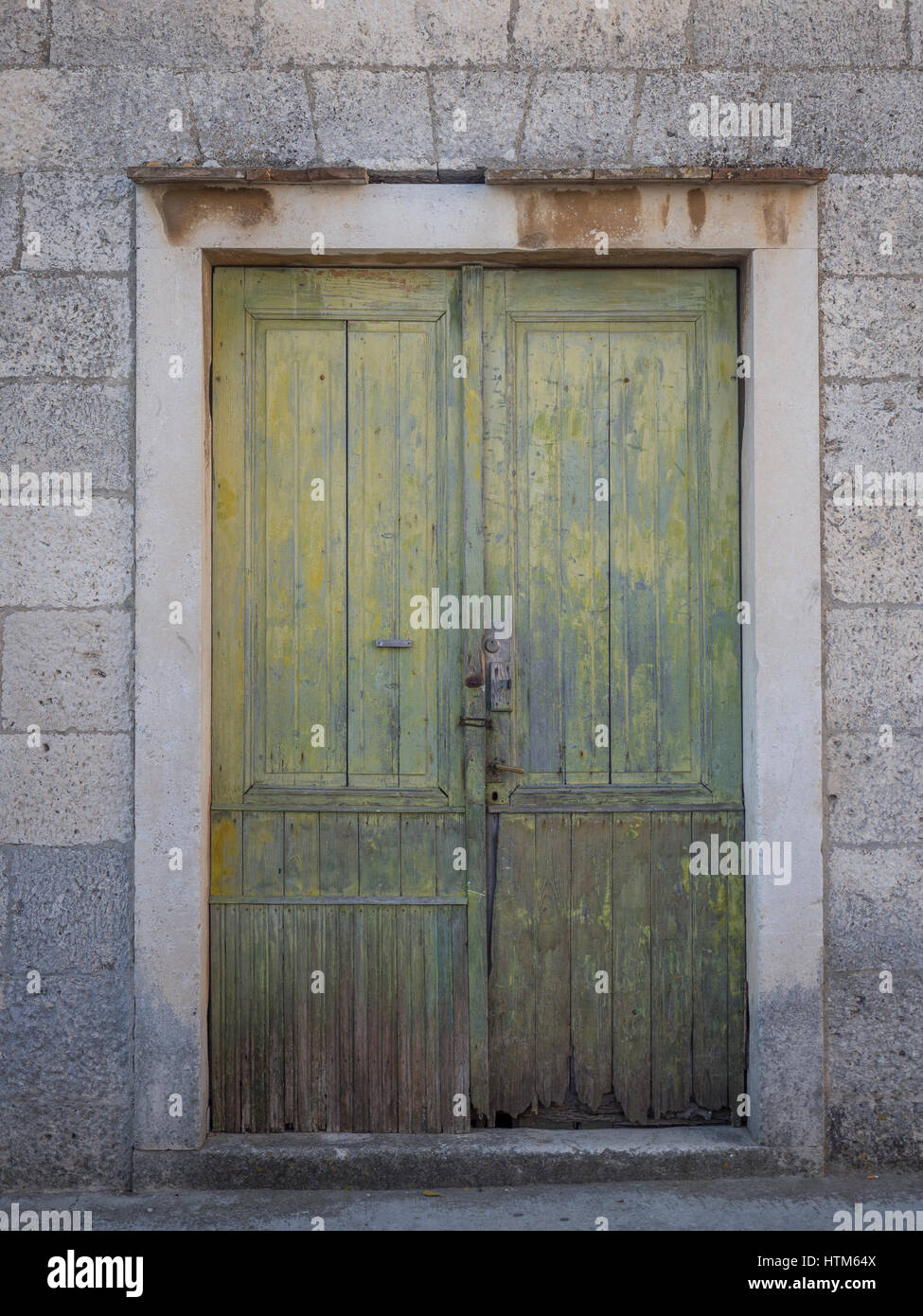Un vieux antique a endommagé la peinture verte de déroulage porte peinte dans le cadre dans mur de pierre Croatie Banque D'Images