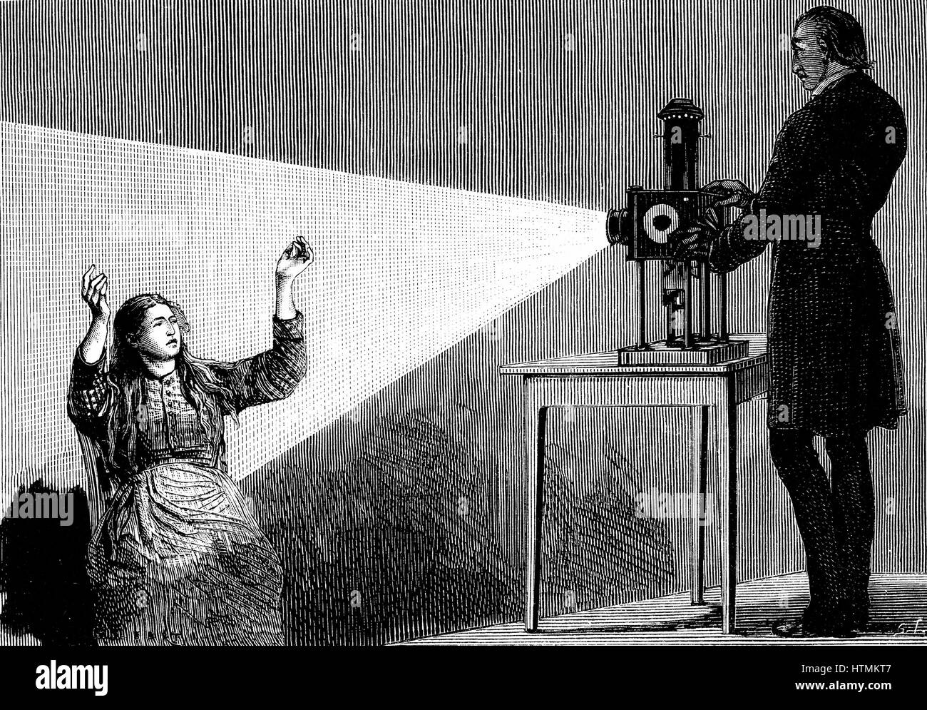 Jean Martin CHARCOT (1825-1903), neurologue français et le pathologiste, démonstration de la production de l'hypnose à l'aide de faisceau de lumière d'une lanterne magique. Photo tirée de la vie à l'hôpital Salpetriere, Paris. Freud a entendu de posthypnotic suggestion de Charcot. Gravure tirée de 'La nature', Paris, 1879 Banque D'Images
