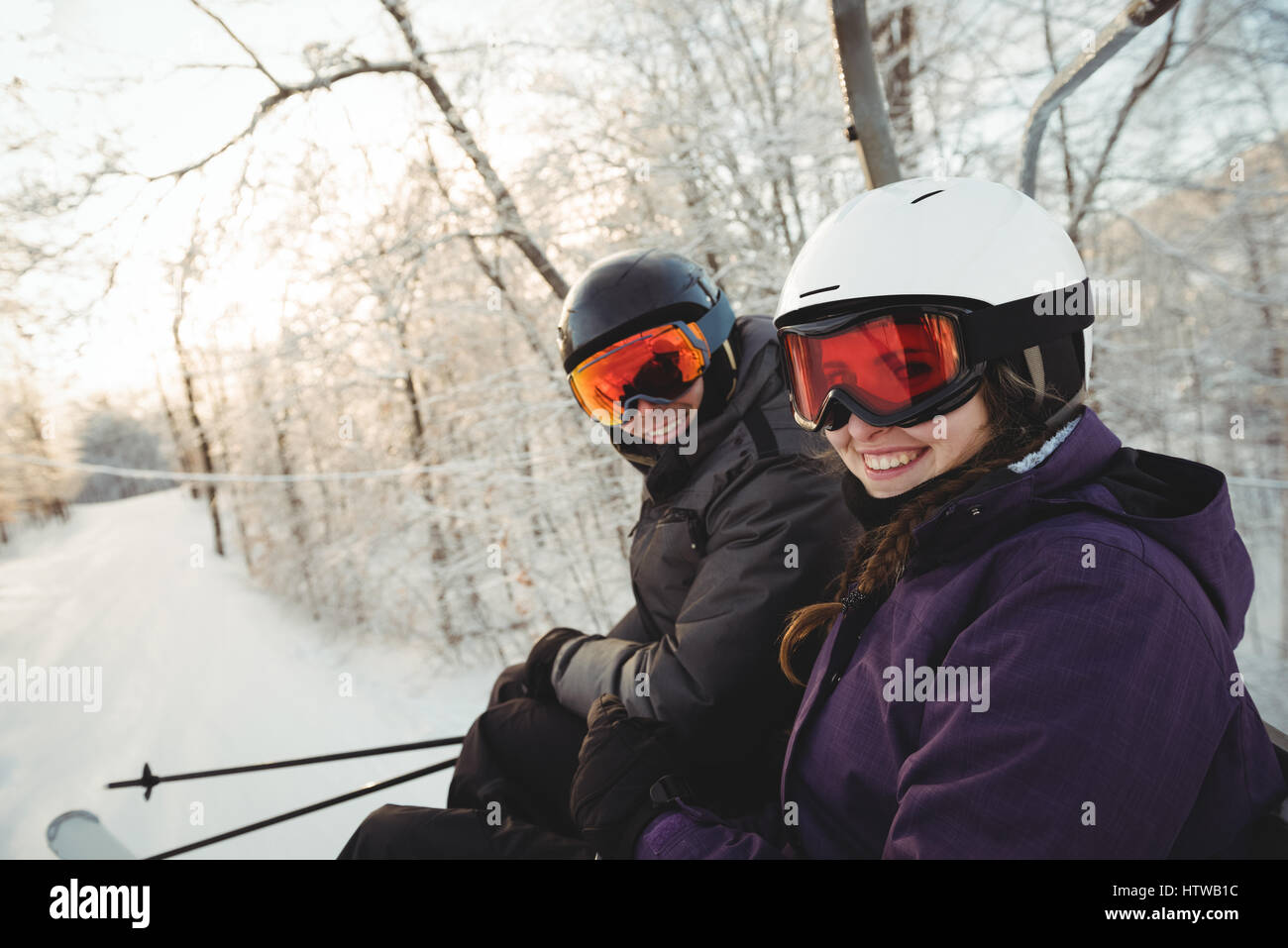 Heureux couple skieur assis à la station de ski Banque D'Images
