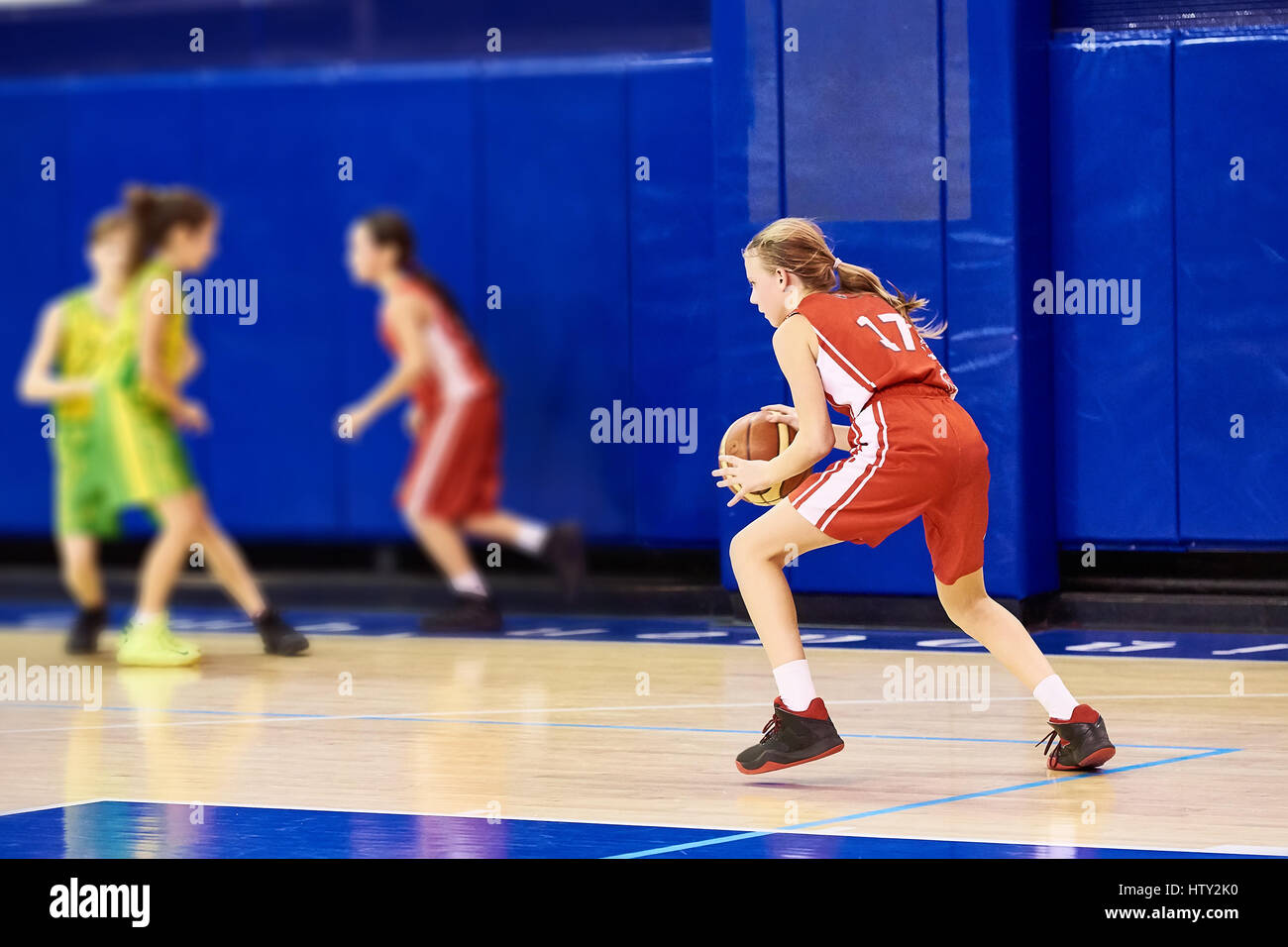 Les filles dans le sport de l'athlète de basket-ball de jeu uniformes à l'intérieur Banque D'Images