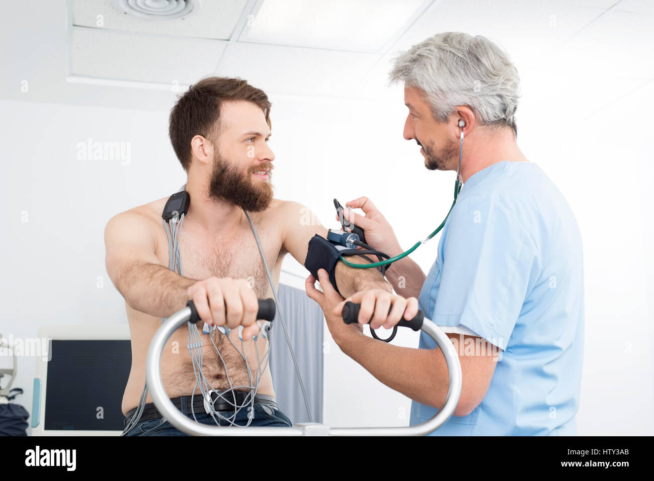 Médecin la mesure de la pression artérielle du patient à l'hôpital de vélo Banque D'Images