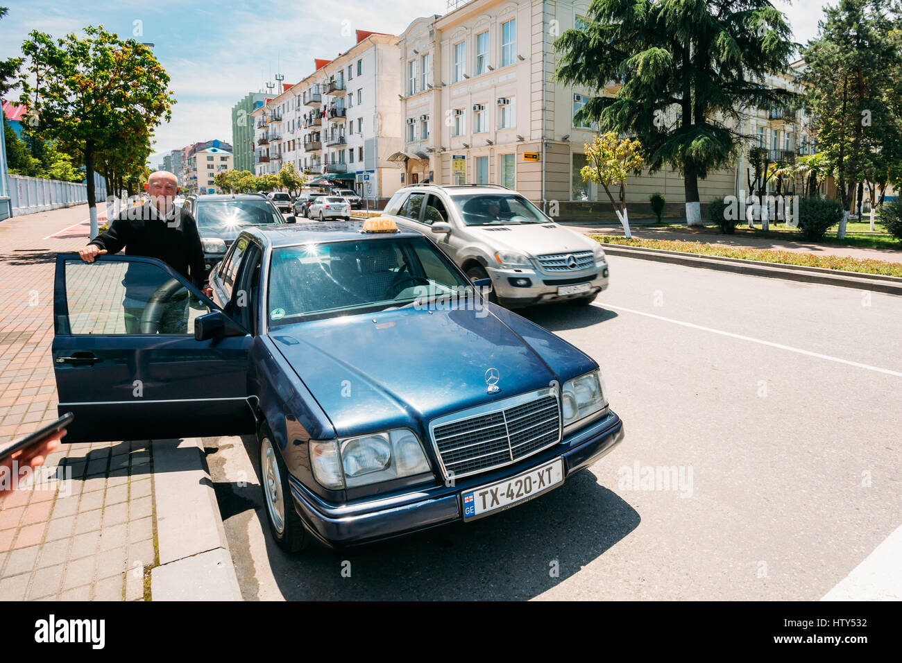 Batumi, Géorgie, l'Adjarie - 25 mai 2016 : Vieil Homme Chauffeur en attente pour les passagers près de voiture Taxis Banque D'Images