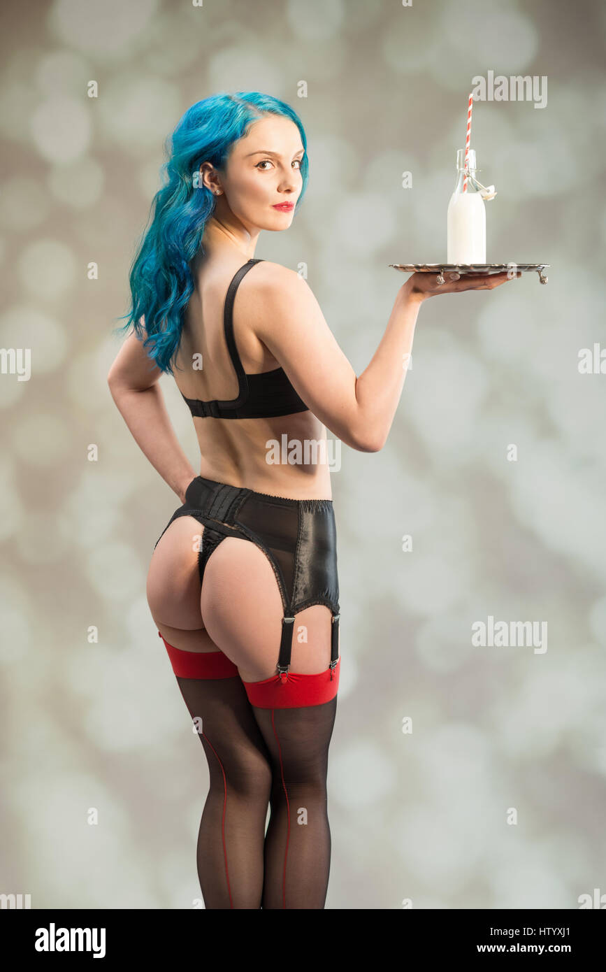 Pin up girl aux cheveux bleus holding a silver tray retro avec bouteille de lait et la paille Banque D'Images
