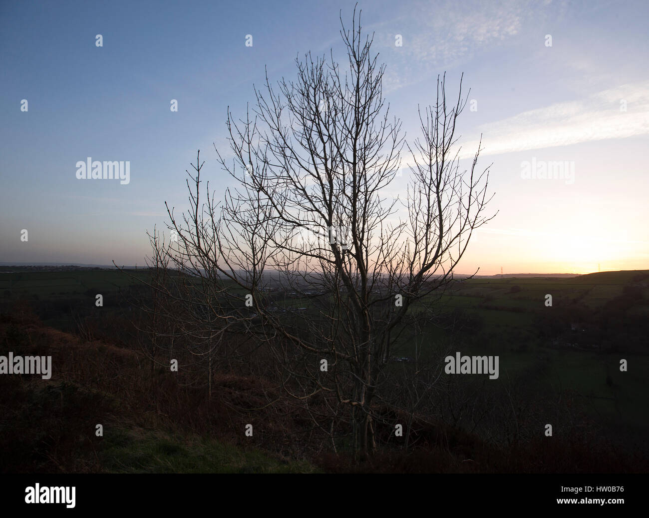 Halifax, Royaume-Uni. Mar 15, 2017. Météo britannique. Le soleil se couche à la fin d'une belle journée de printemps sur les collines des Pennines entourant la ville, Halifax West Yorkshire, Calderdale. Halifax est une ville de la cathédrale dans la région métropolitaine de Calderdale dans West Yorkshire, Angleterre. La ville a été un centre de fabrication de laine du 15ème siècle, à l'origine traiter par la Pièce Hall. Halifax est connu pour guide du chocolat et le caramel produits, y compris la qualité de l'Arlo et rue. La Halifax Building Society a également été fondée à Halifax. Credit : Moulin Images/Alamy Live News Banque D'Images