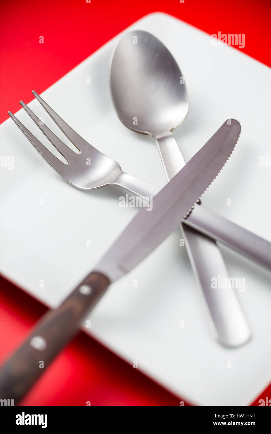 Des couverts et de la plaque avec un fond rouge Banque D'Images