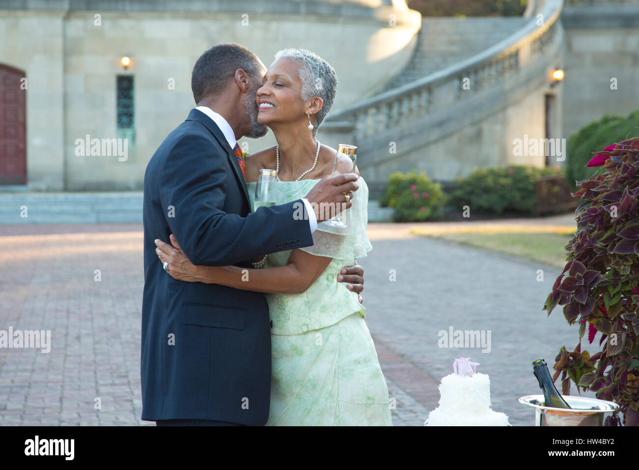 Black couple hugging près de gâteau de mariage Banque D'Images