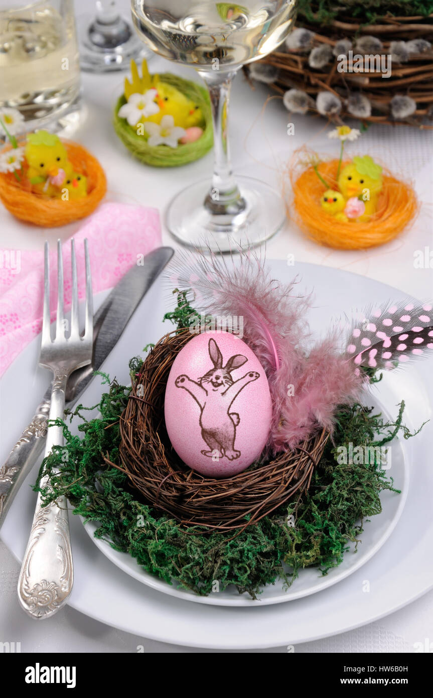 Avec un lapin oeufs stamp dans un nid sur une mousse, comme le décor d'une table pour Pâques Banque D'Images