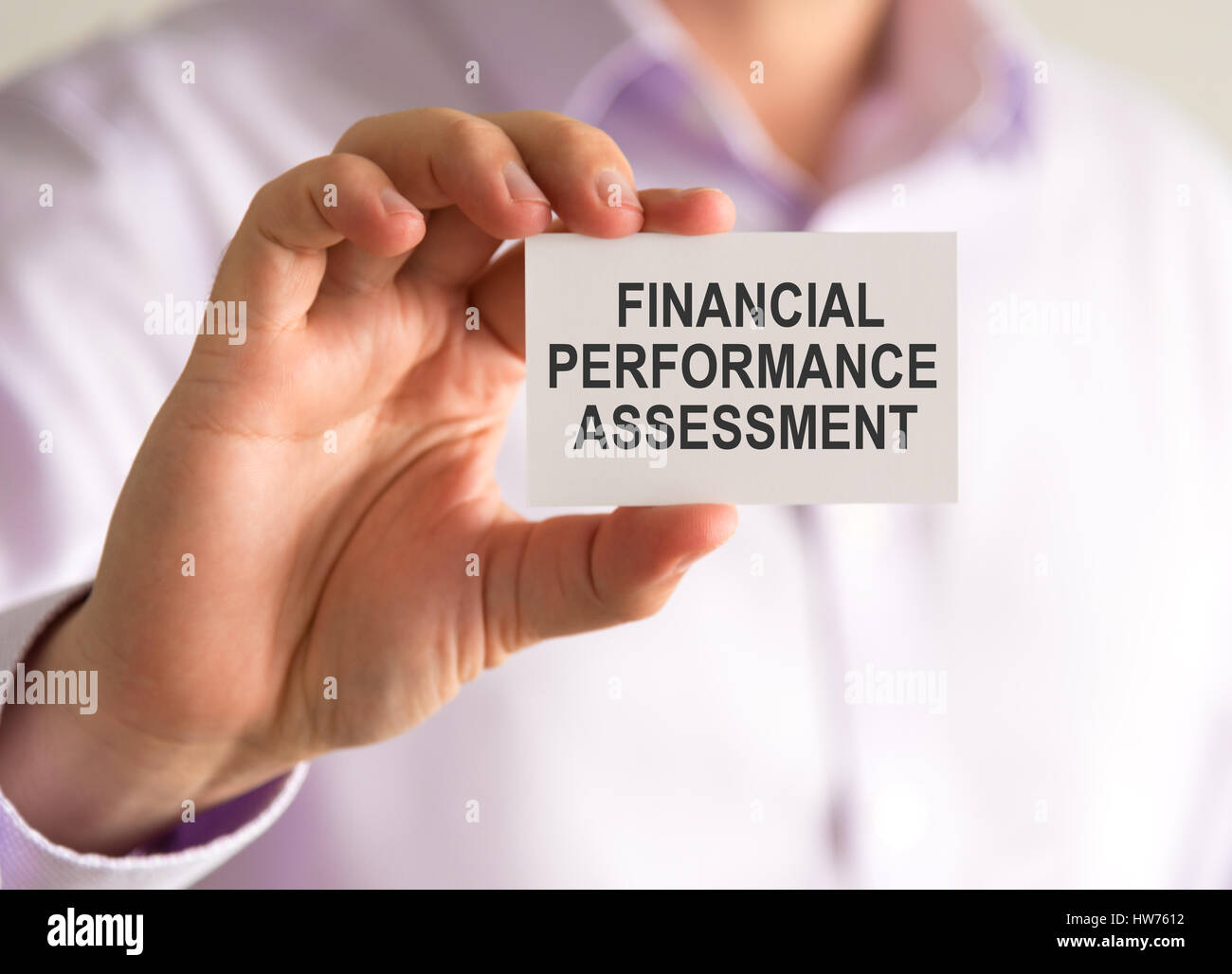 Gros plan sur businessman holding une carte avec un message d'ÉVALUATION DU RENDEMENT FINANCIER, concept d'entreprise image avec arrière-plan flou Banque D'Images