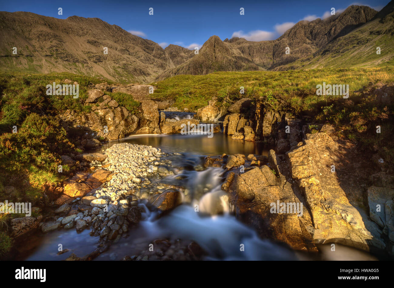 Piscines avec cascades fées Sgurr une Fheadain et montagnes Cuillin en lumière au coucher du soleil, à l'île de Skye, en Ecosse Banque D'Images