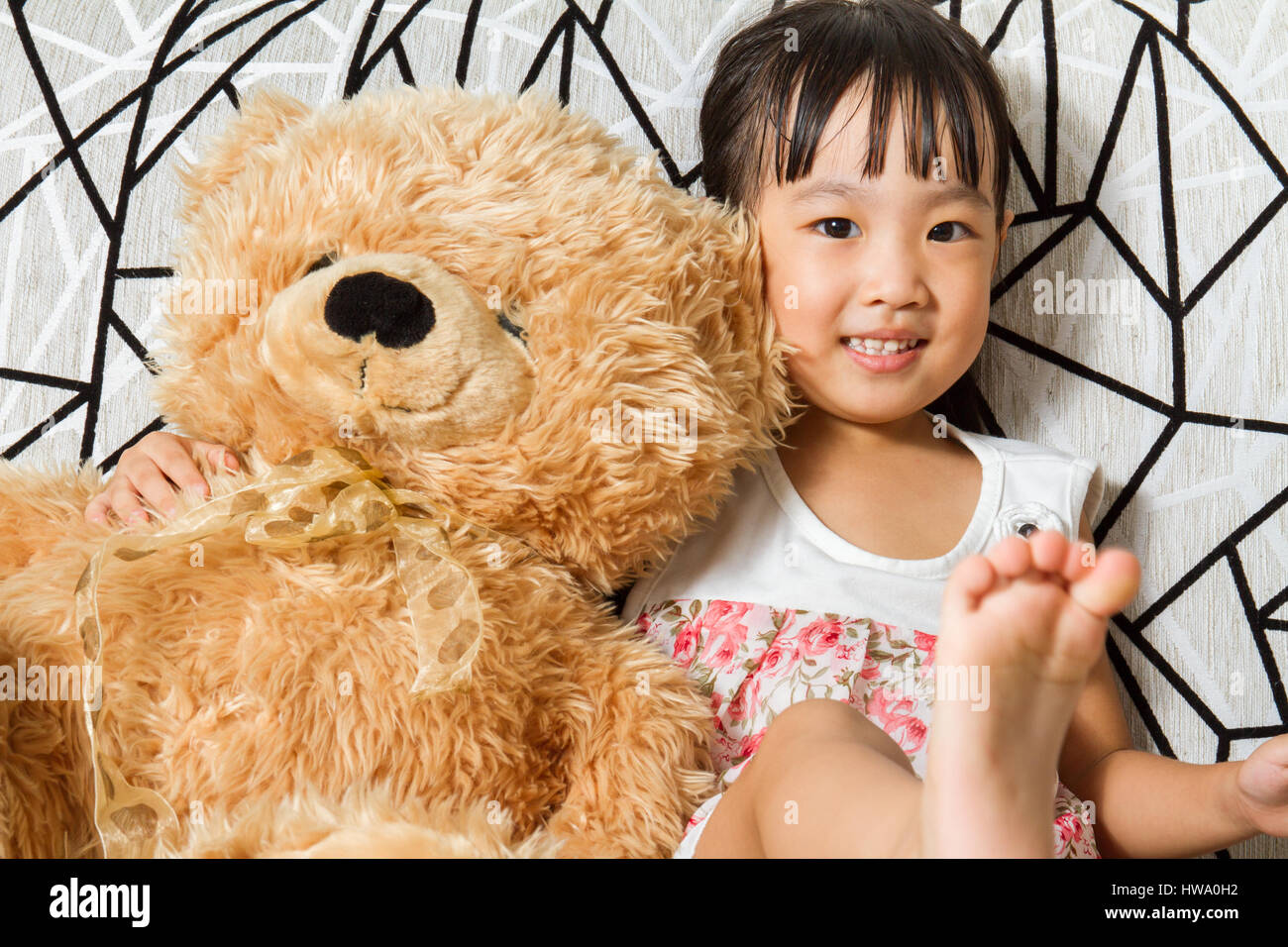 Petite fille asiatique chinois avec des ours en peluche à la maison Banque D'Images